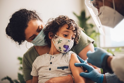 Kid receiving covid vaccine at home